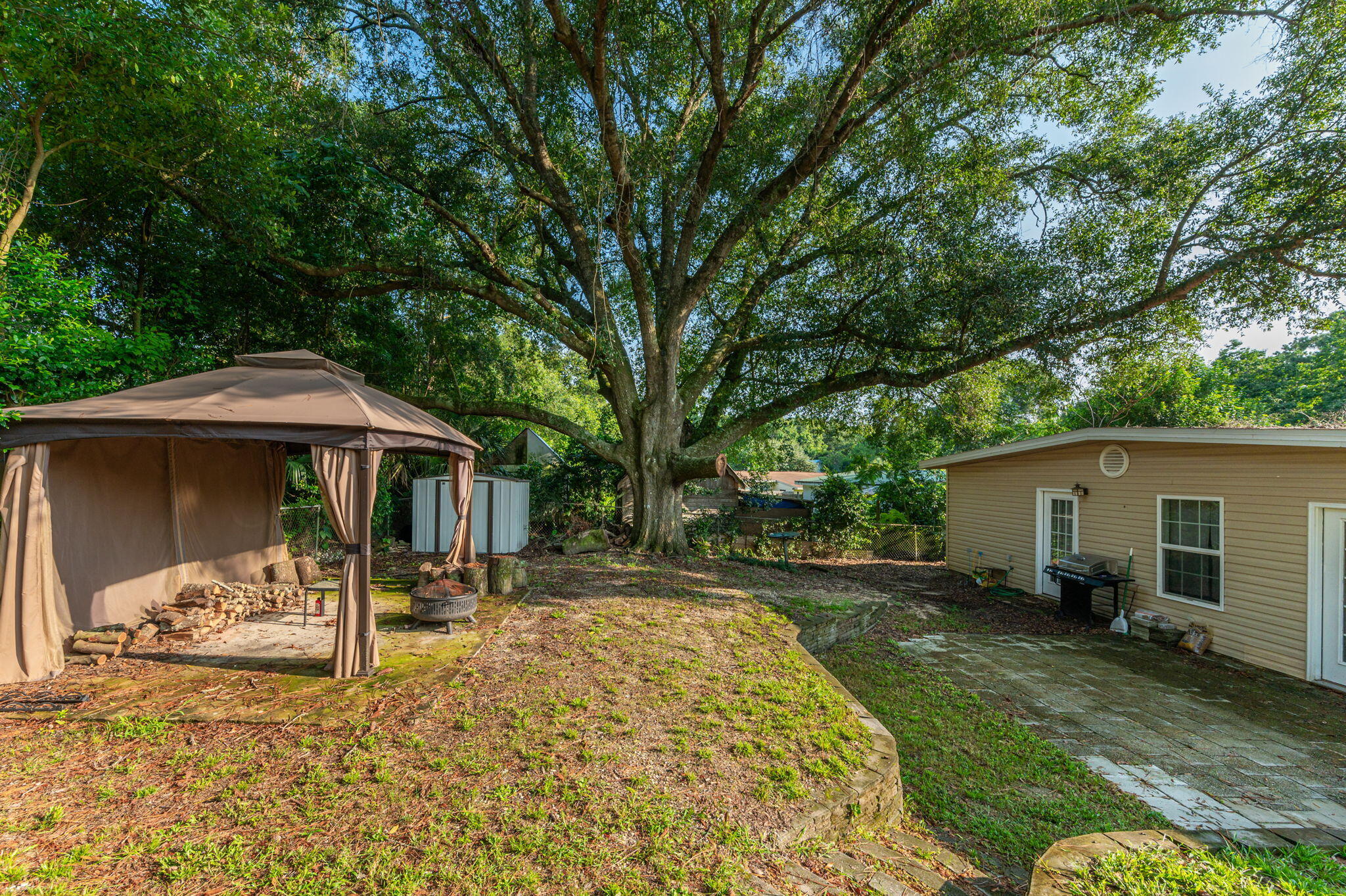 111 Sikes Drive Crestview, FL 32539 - Photo 41 of 46 a view of a patio with table and chairs under an umbrella