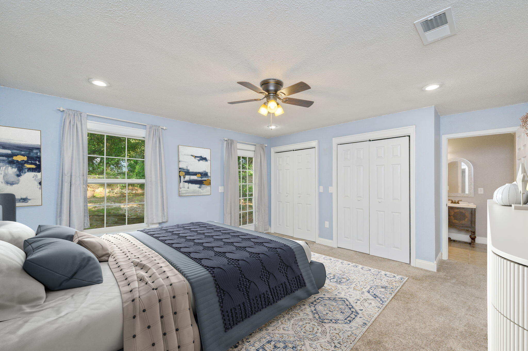 111 Sikes Drive Crestview, FL 32539 - Photo 7 of 46 a bedroom with a large bed and a chandelier