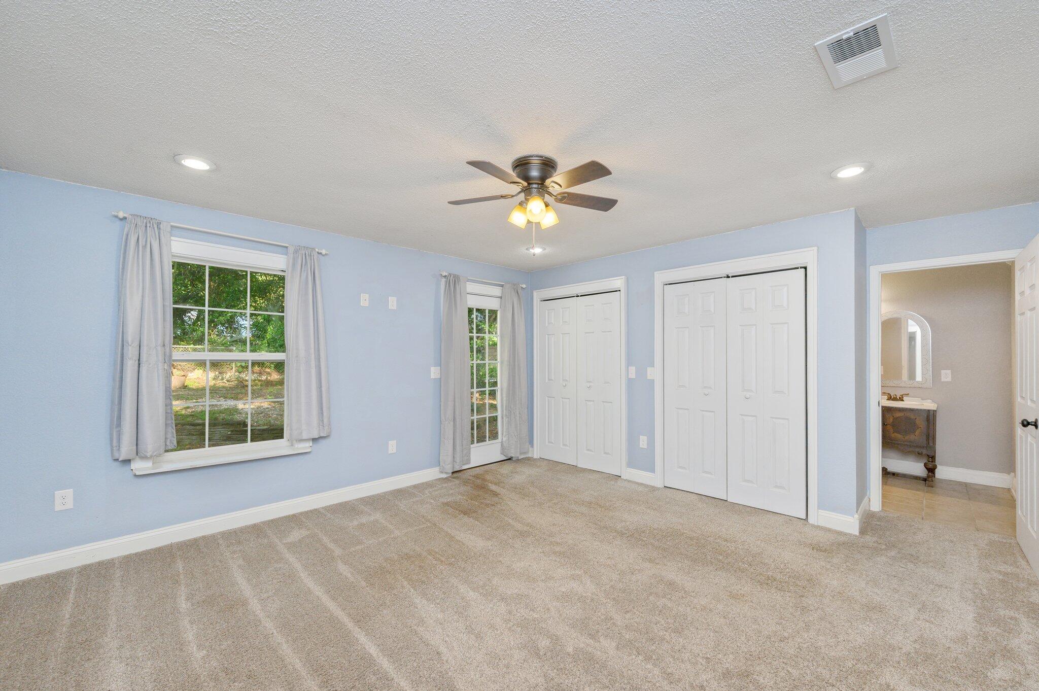 111 Sikes Drive Crestview, FL 32539 - Photo 8 of 46 an empty room with fan and a ceiling fan
