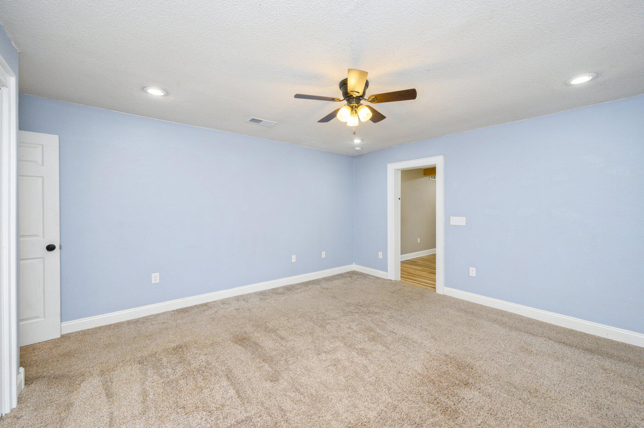 111 Sikes Drive Crestview, FL 32539 - Photo 9 of 46 a view of room with a ceiling fan and hardwood floor