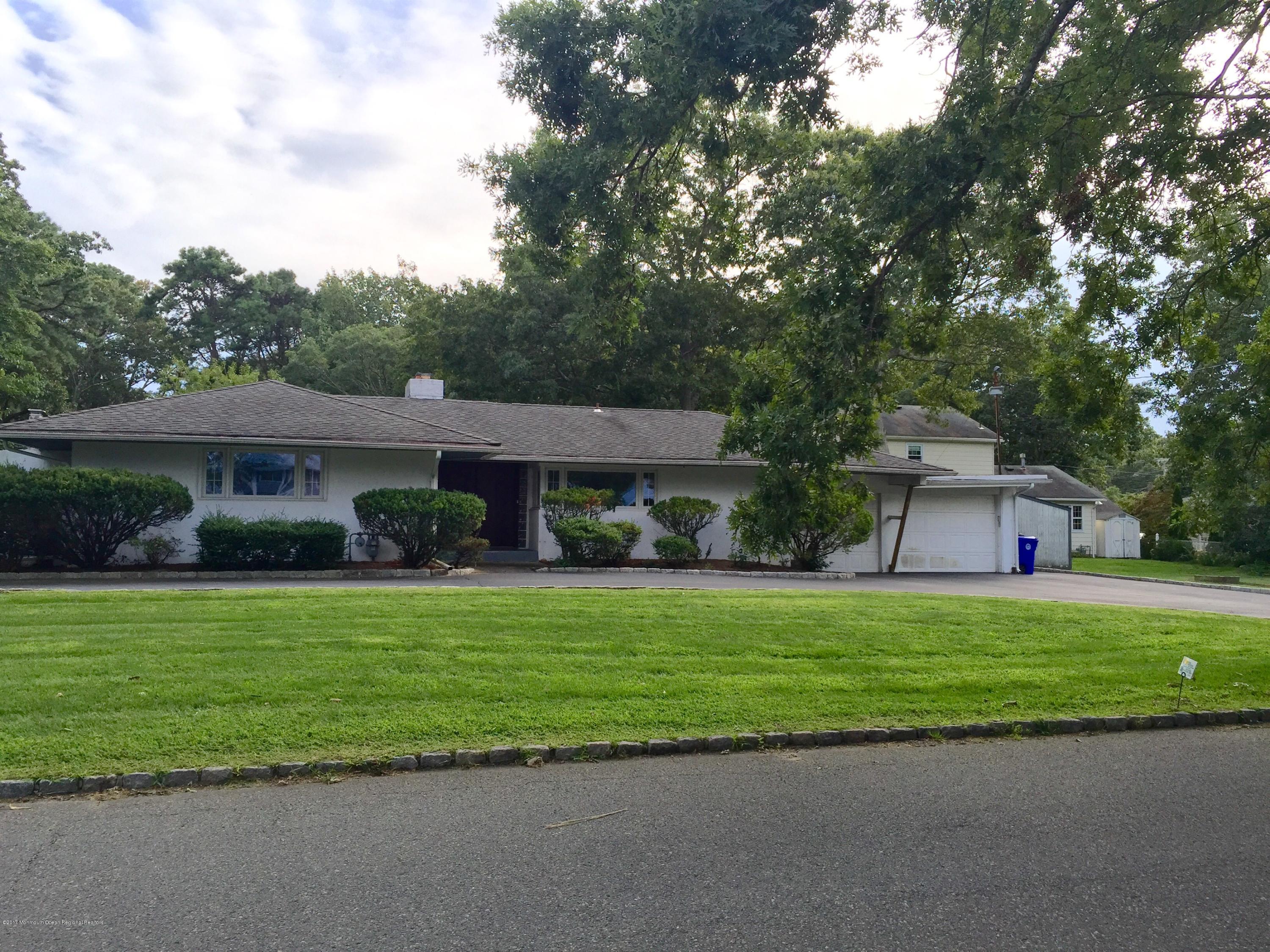 509 Nicholas Road Brick, NJ 08724 - Photo 8 of 8 a front view of a house with a garden and trees
