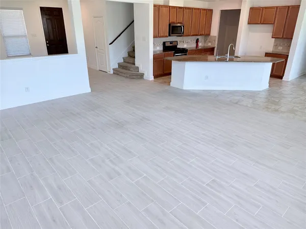 a kitchen with kitchen island granite countertop a stove sink and cabinets