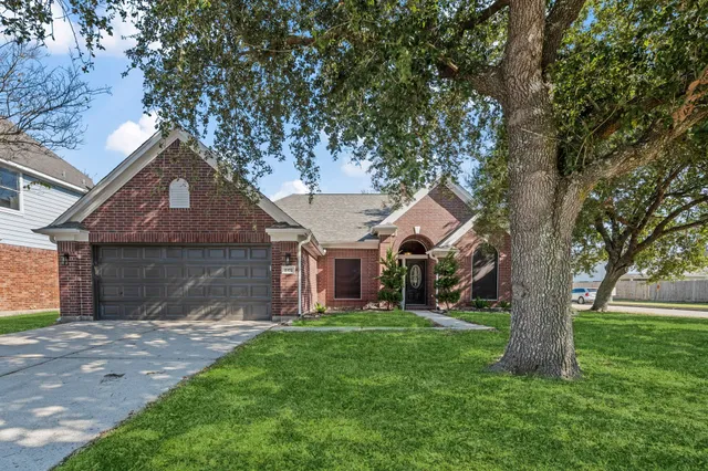 front view of a house with a tree in a yard