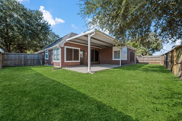 a view of a house with a yard and tree