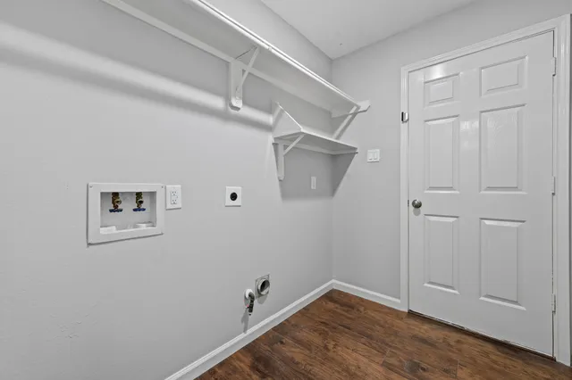 a view of a room with wooden floor