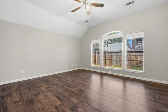 wooden floor in an empty room with a window