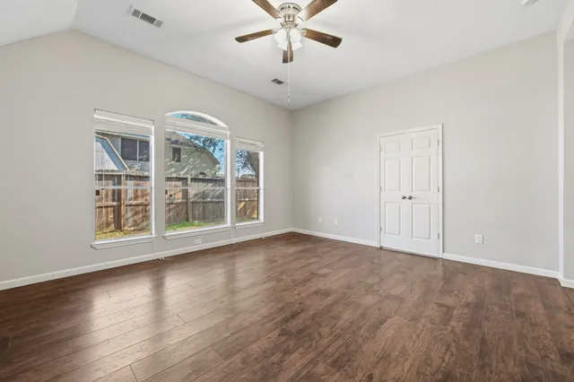 wooden floor in an empty room with a window