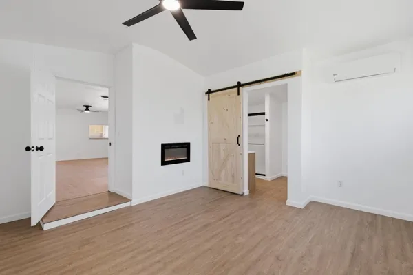 a view of empty room with wooden floor