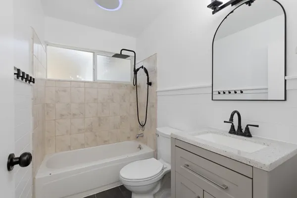 a bathroom with a sink a toilet and a mirror