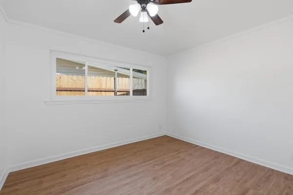 wooden floor in an empty room with a window