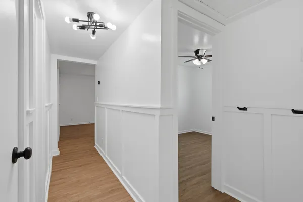 a view of a hallway with a chandelier