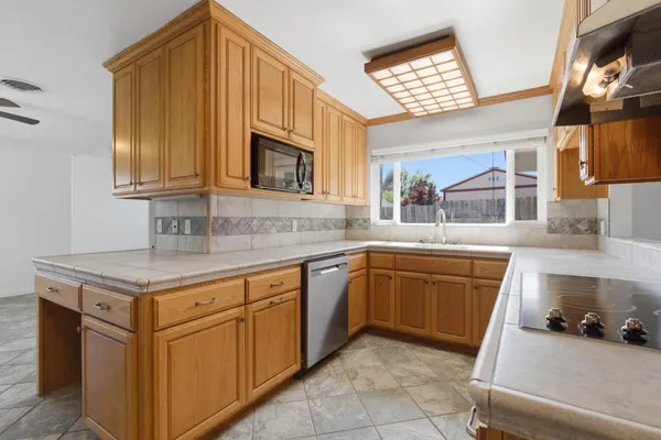a kitchen that has a sink and a stove in it