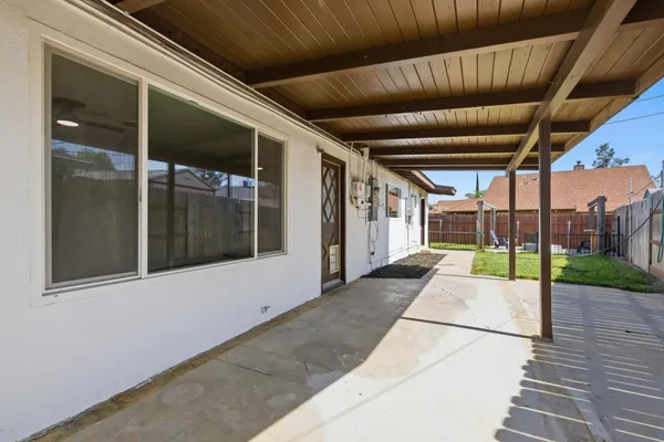 a view of a chair and tables in the patio