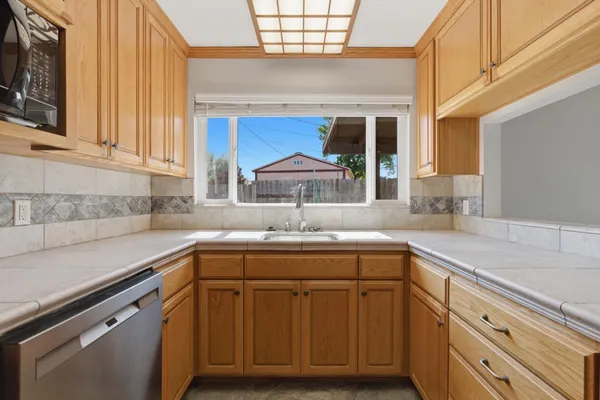 a kitchen with a sink cabinets and window