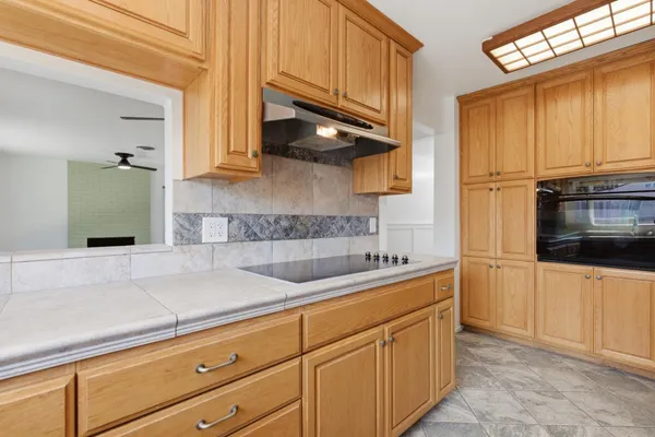 a kitchen with stainless steel appliances granite countertop a sink a stove and cabinets