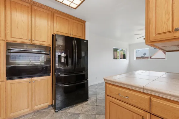 a kitchen with granite countertop a refrigerator stove and microwave