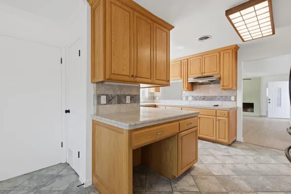 a kitchen with a sink cabinets and wooden floor