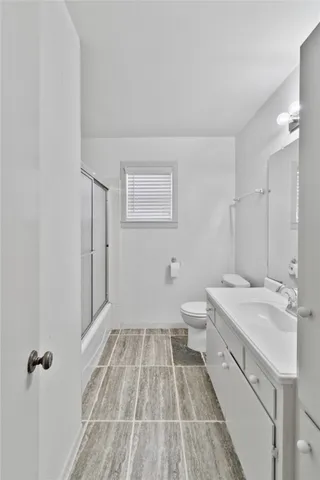 a bathroom with a sink a toilet and mirror