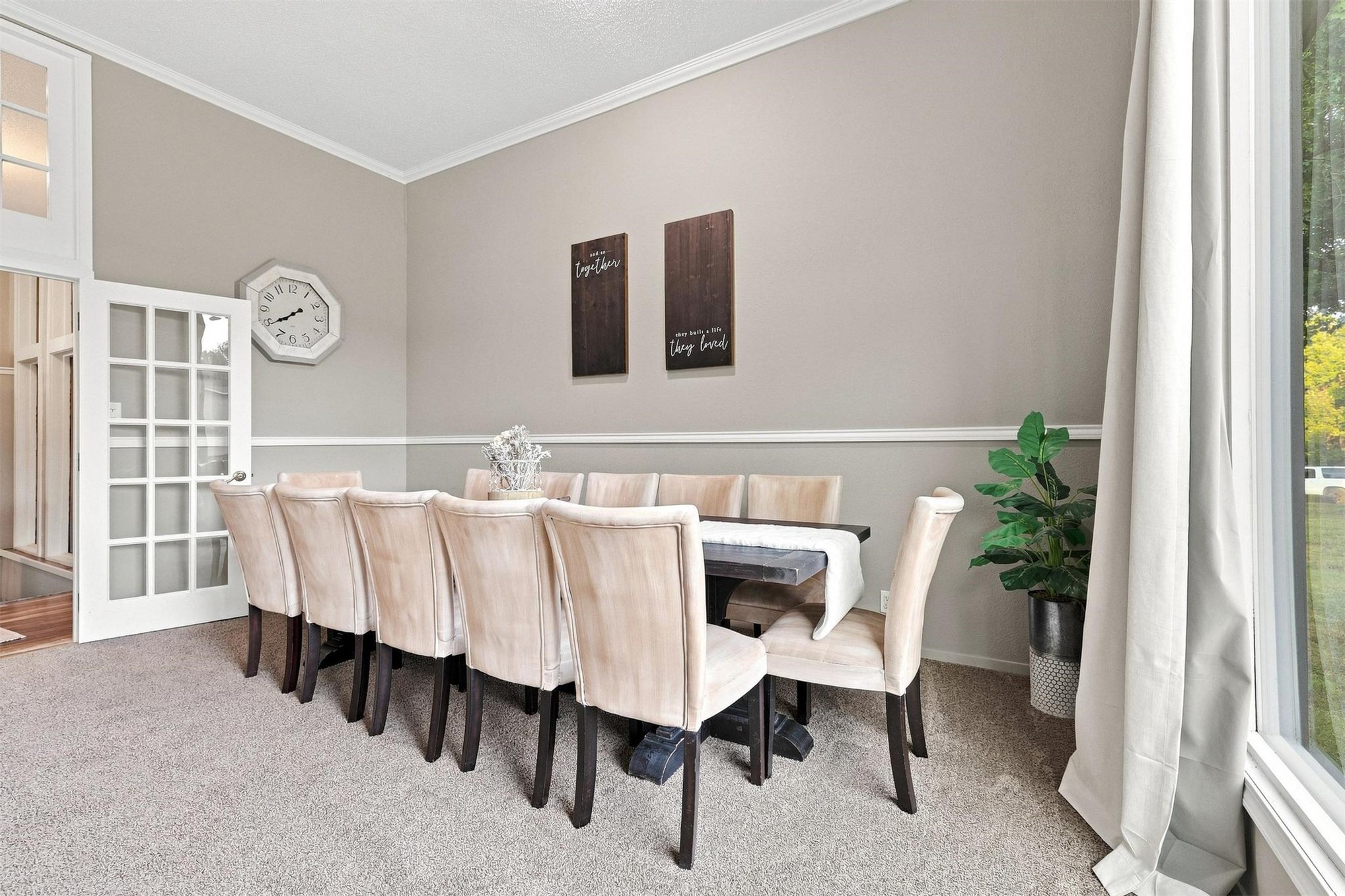 Neutral tone painted walls with white crown molding, chair rail, and baseboards