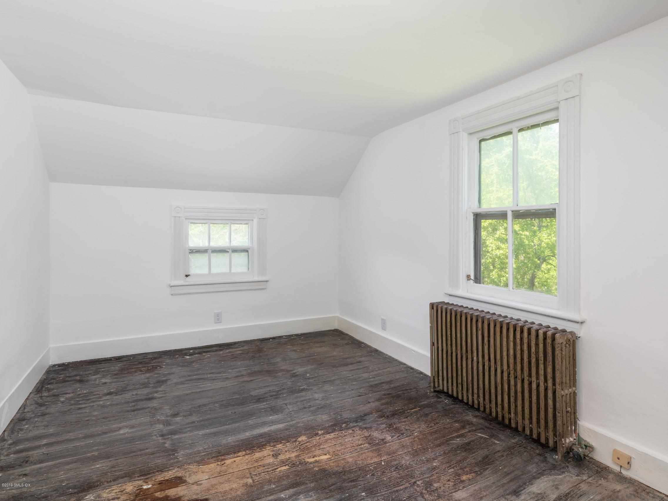 566 River Road Cos Cob, CT 06807 - Photo 13 of 22 an empty room with wooden floor and windows