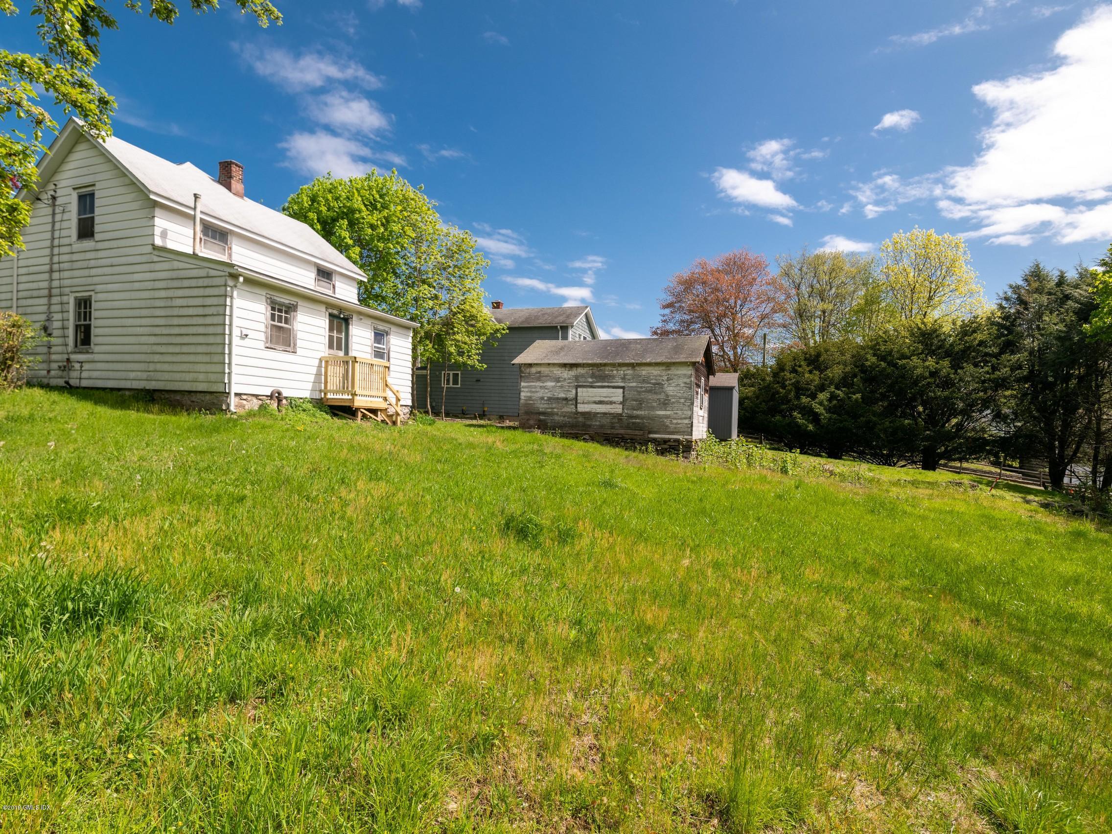 566 River Road Cos Cob, CT 06807 - Photo 17 of 22 a view of a house with a back yard