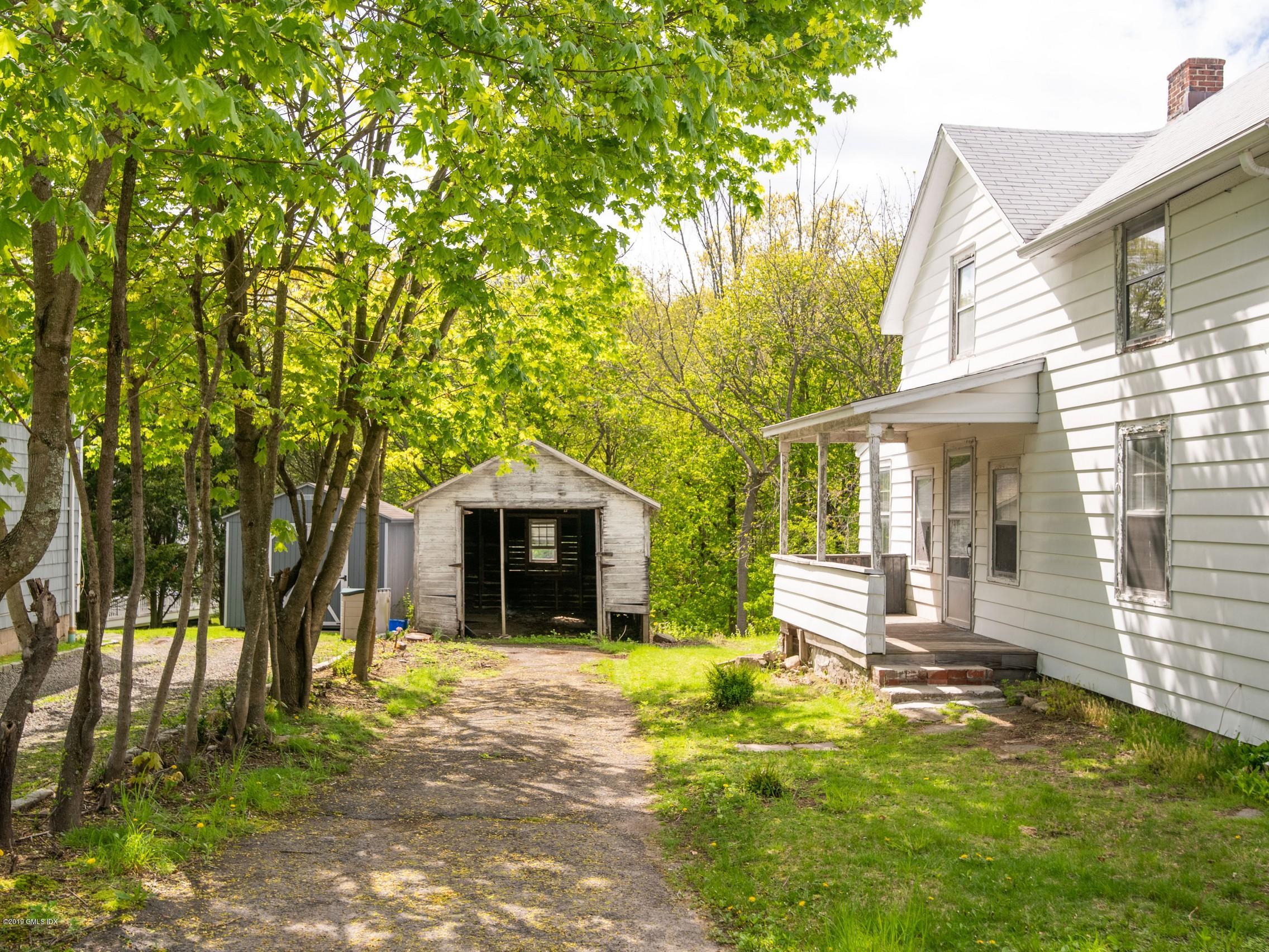 566 River Road Cos Cob, CT 06807 - Photo 3 of 22 a front view of a house with a yard and large tree