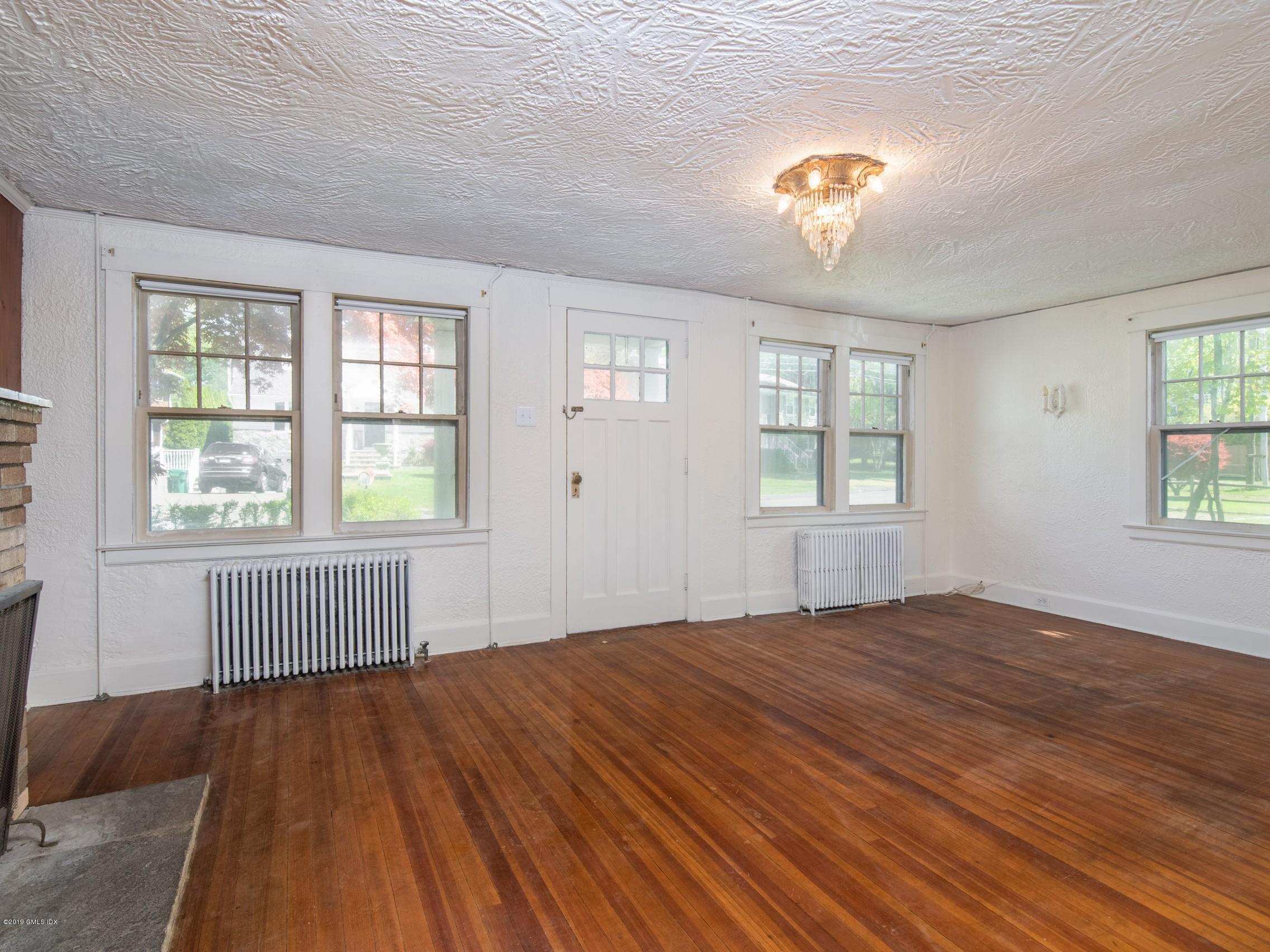 566 River Road Cos Cob, CT 06807 - Photo 5 of 22 wooden floor in an empty room with a window