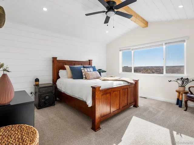 a bed room with a bed and a chair