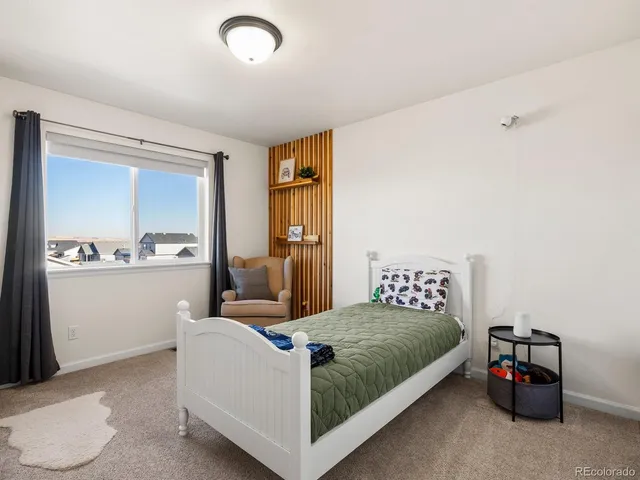 a bedroom with a bed and a couch