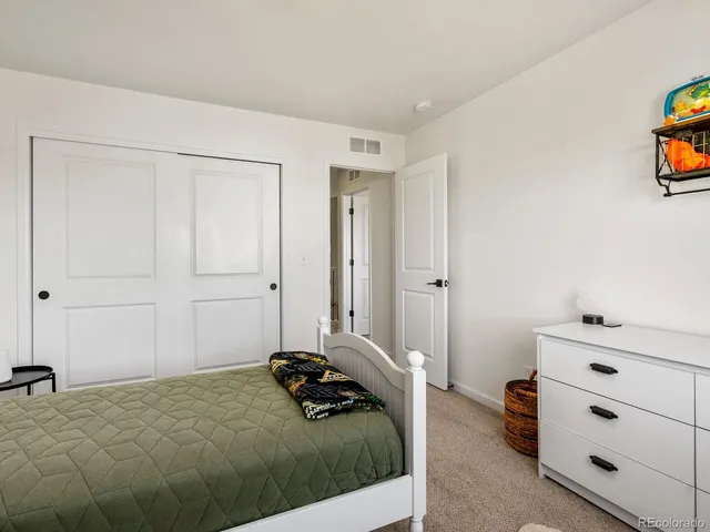 a bedroom with a bed and cabinets