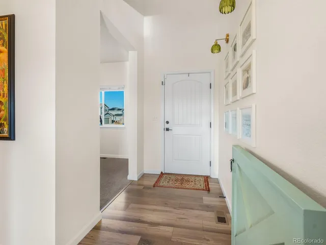 a view of an entryway with wooden floor