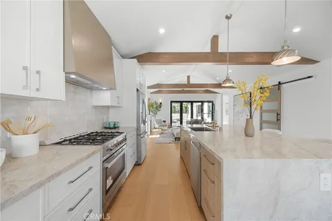 a kitchen with counter top space cabinets and stainless steel appliances