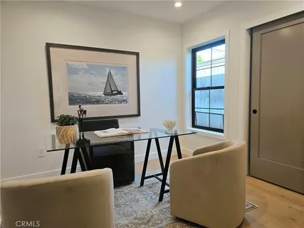 a living room with furniture a mirror and a lamp