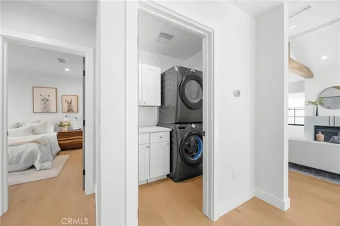 wooden floor with table and a mirror
