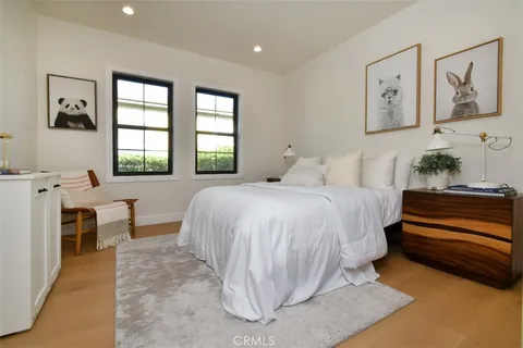 a bedroom with a bed and a painting on the wall