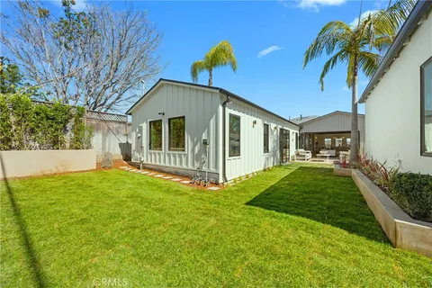 a backyard of a house with table and chairs