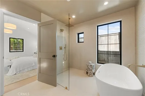 a bathroom with a granite countertop sink a toilet a mirror and shower