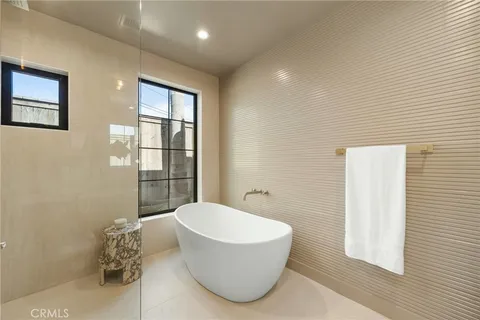 a bathroom with a bathtub and a shower