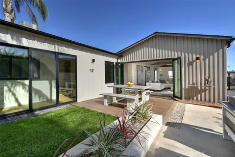 a view of a patio with table and chairs and potted plants