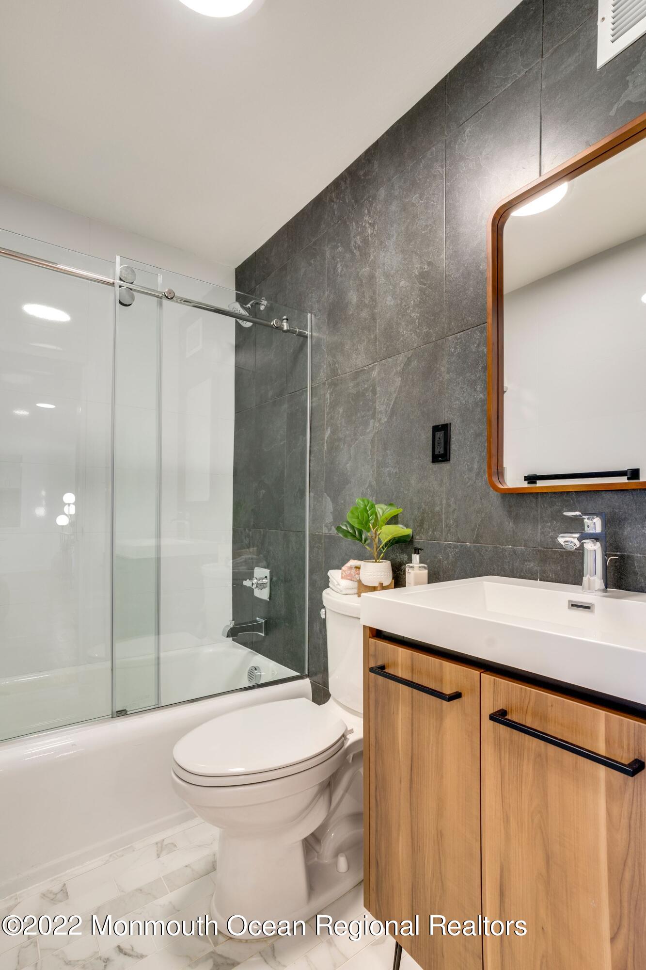 122 Bodman Place, Unit B5 Red Bank, NJ 07701 - Photo 19 of 29 a bathroom with a sink a toilet and shower