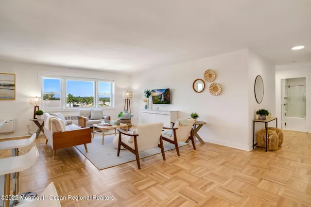 a living room with furniture kitchen view and a table