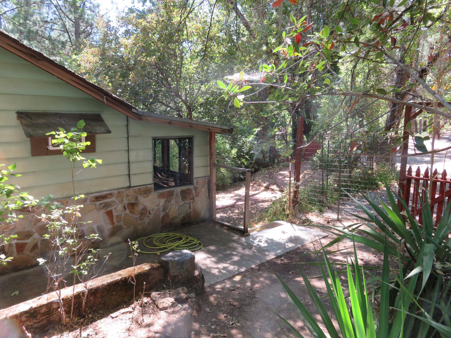 2563 Woodhouse Mine Road West Point, CA 95255 - Photo 15 of 49 a backyard of a house with table and chairs