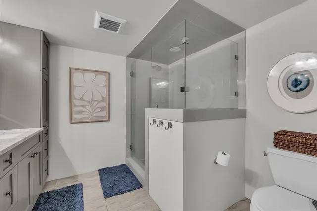 a spacious bathroom with a double vanity sink and a mirror