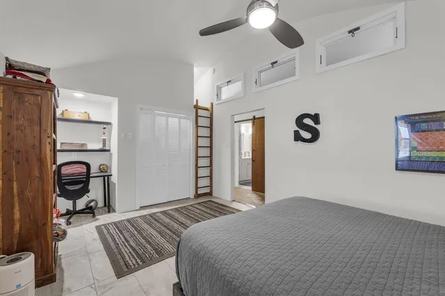 a bedroom with bed and a book shelf