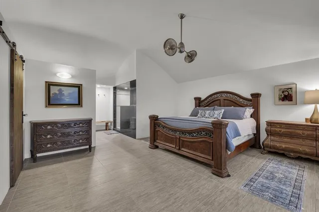 a bedroom with a bed and a dresser