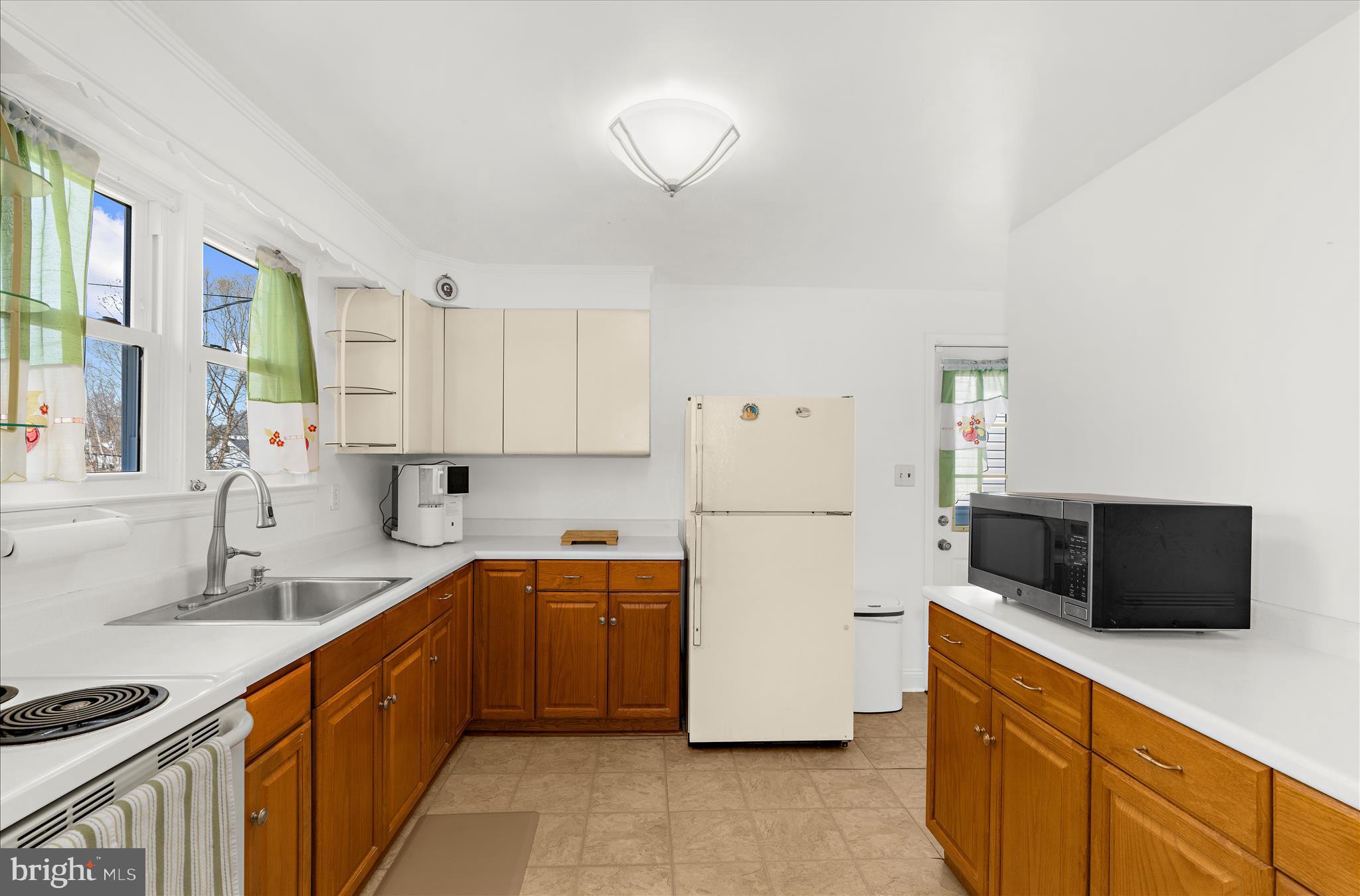 534 Cleveland Road Linthicum Heights, MD 21090 - Photo 6 of 30 a kitchen with a sink cabinets and stainless steel appliances