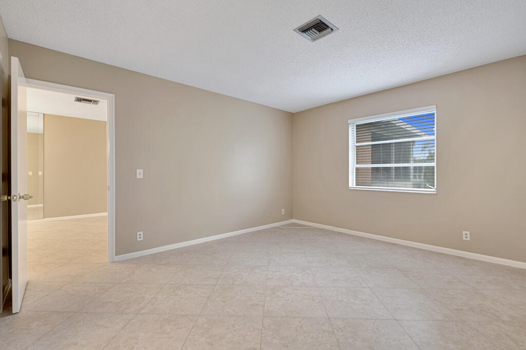 2411 Papaya Drive, Unit 202 Delray Beach, FL 33445 - Photo 12 of 23 a view of an empty room with a window