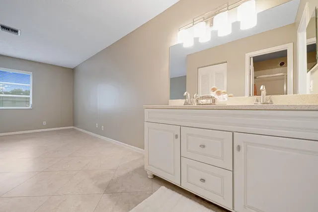 a bathroom with a sink vanity and mirror