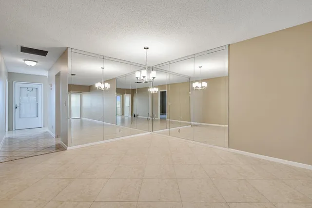 a view of an empty room with a mirror