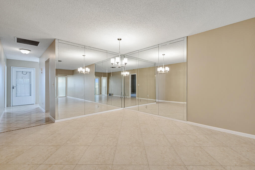 2411 Papaya Drive, Unit 202 Delray Beach, FL 33445 - Photo 19 of 23 a view of an empty room with a mirror